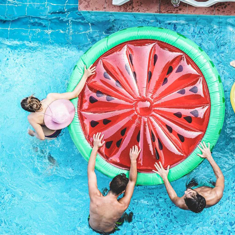 Children playing with an inflatable in a pool