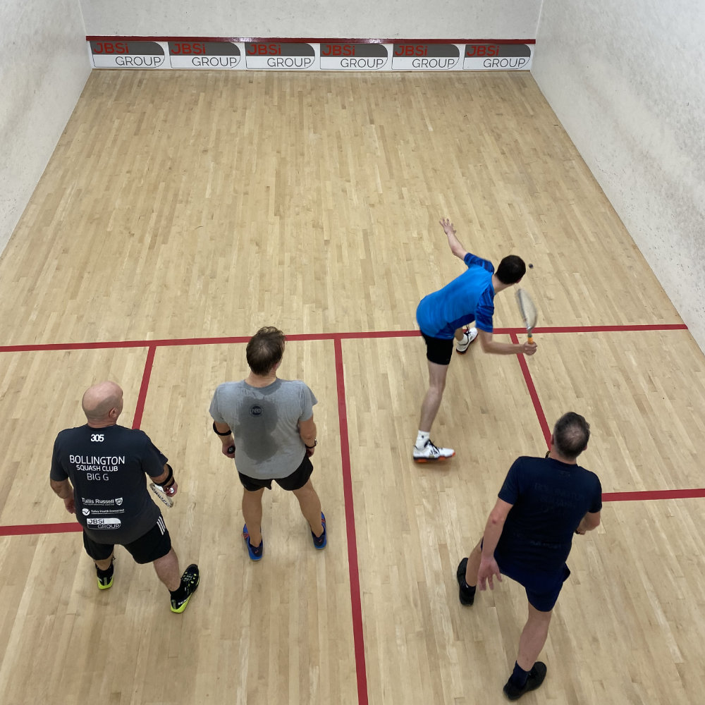 4 men playing squash